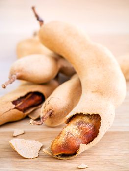 Close up tamarind for homemade skin care and body scrub  set up on wooden background.
