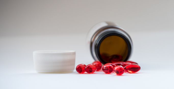 Tabs Vitamins, omega 3, Medications tablets and capsules in a beaker. Medications tablets, suppository bottles, capsules and thermometer on wooden table