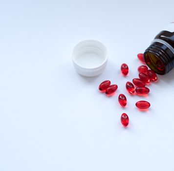 Tabs Vitamins, omega 3, Medications tablets and capsules in a beaker. Medications tablets, suppository bottles, capsules and thermometer on wooden table