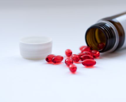 Tabs Vitamins, omega 3, Medications tablets and capsules in a beaker. Medications tablets, suppository bottles, capsules and thermometer on wooden table