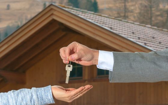 Closeup shot of a female hand receiving house key. Close up hand holding house key.