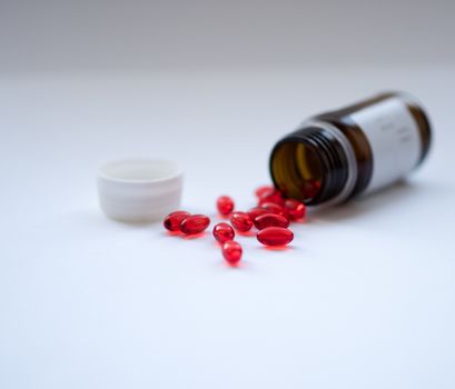 Tabs Vitamins, omega 3, Medications tablets and capsules in a beaker. Medications tablets, suppository bottles, capsules and thermometer on wooden table