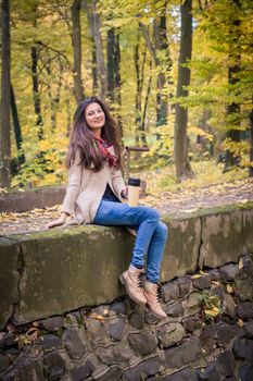 girl sitting on the concrete stone in the Park