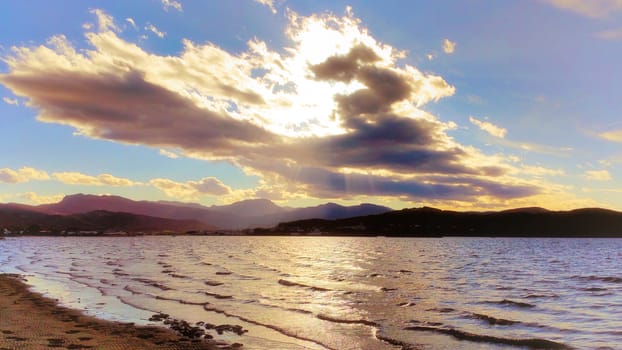 the sun in the clouds, reflection on the river