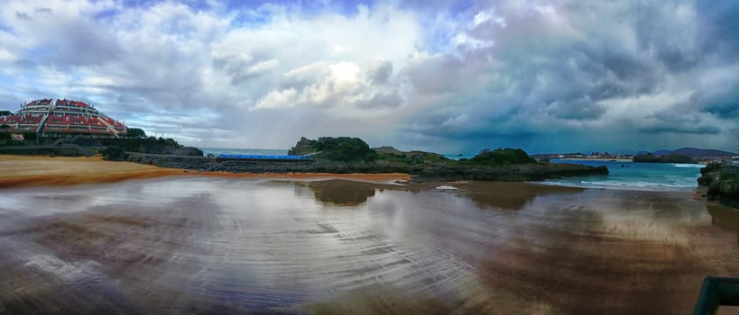 Reflection clouds on the sea. View on the seacoast, panoramic photo