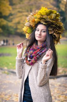 girl with a wreath of leaves in autumn Park