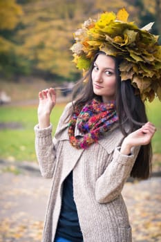 girl with a wreath of leaves in autumn Park