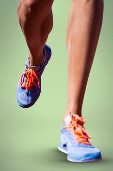 Close up of sportsman legs walking on a white background against green background