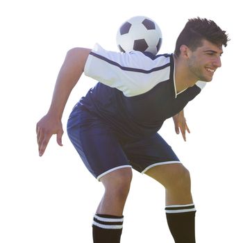 Man soccer player keeping the ball on his back on a white background