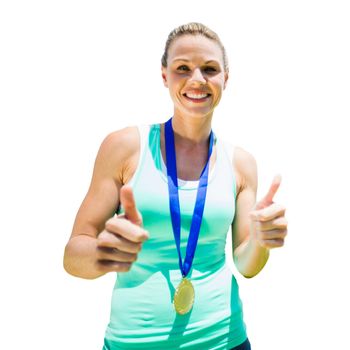 Portrait of smiling sportswoman holding a medal after a victory in a white background 