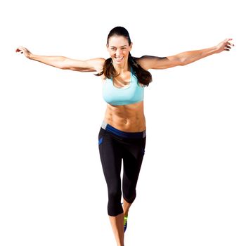 Happy sportswoman is raising arms in a white background