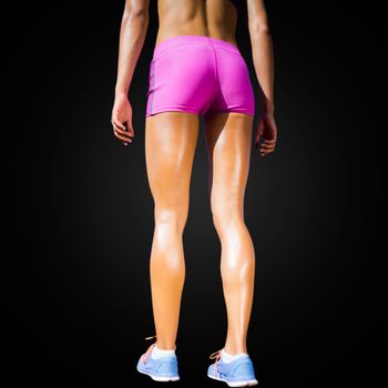 Close up of sportswoman legs with sweat in a black background
