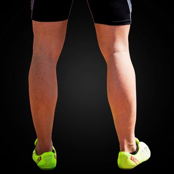 Close up of sportsman legs on a white background in a black background 