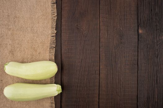 Zucchini on an old wooden table. Top view.