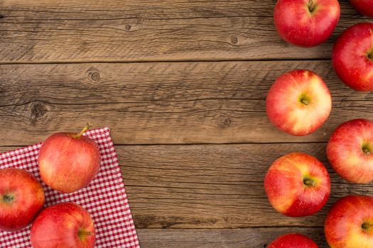 Red apples on the old wooden table. Top view.