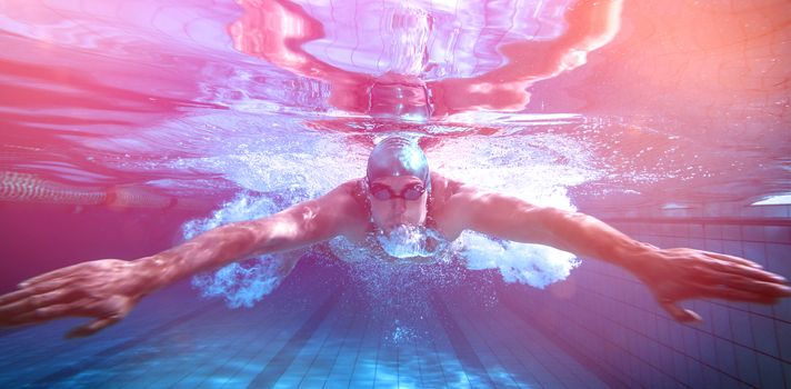 Fit swimmer training by himself in the swimming pool at the leisure centre