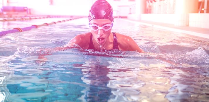 Fit swimmer coming up for air in the swimming pool at the leisure center