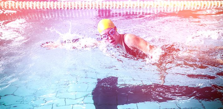 Side view of swimmer woman swimming in the swimming pool