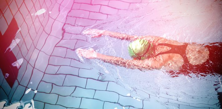 Fit woman swimming with swimming hat in swimming pool