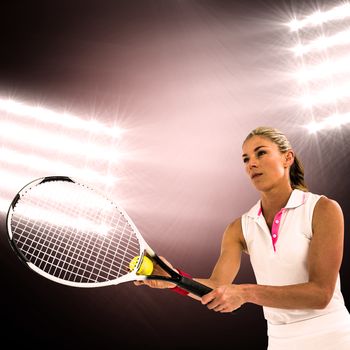 Athlete playing tennis with a racket  against spotlight