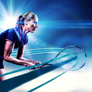 Tennis player playing tennis with a racket  against spotlights