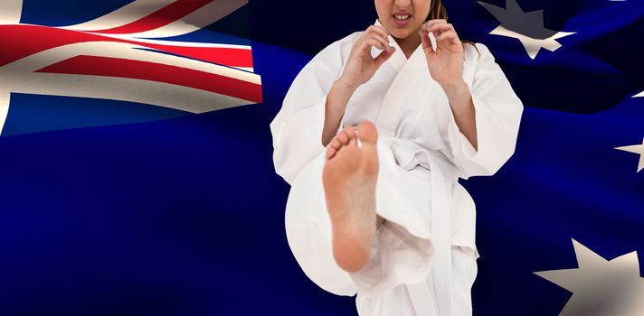 Fighter performing karate stance against australia flag waving