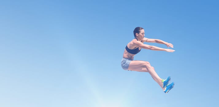 Sportswoman jumping on a white background against scenic view of blue sky