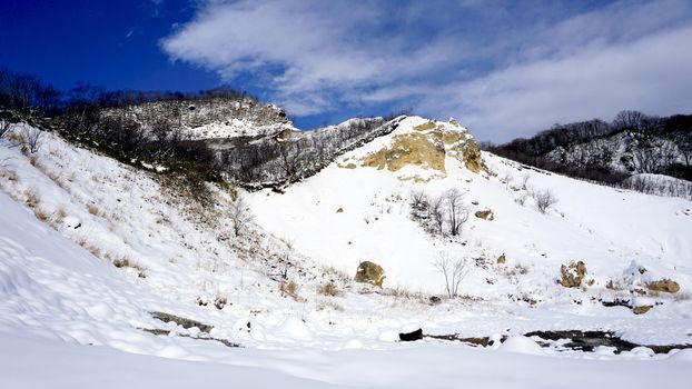 Noboribetsu onsen snow mountain bluesky hell valley winter national park in Jigokudani, Hokkaido, Japan