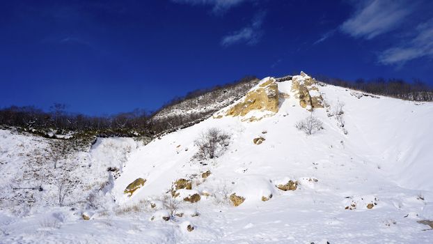 Noboribetsu onsen snow mountain bluesky hell valley winter national park in Jigokudani, Hokkaido, Japan