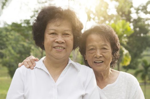 Portrait of healthy happy Asian seniors mother and daughter at outdoor nature park, morning beautiful sunlight background.