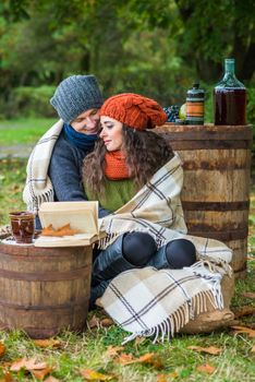 loving young couple sitting in the autumn garden