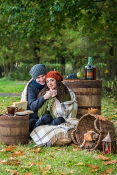 loving couple sitting in the autumn garden