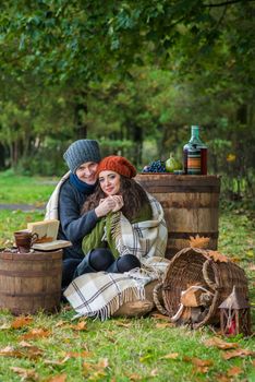 loving young couple sitting in the autumn garden