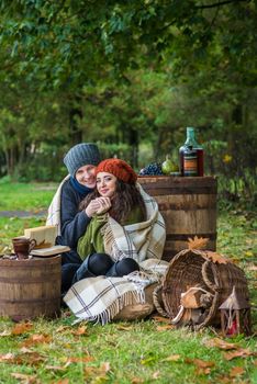 loving young couple sitting in the autumn garden