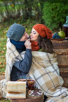 loving couple sitting in the autumn garden