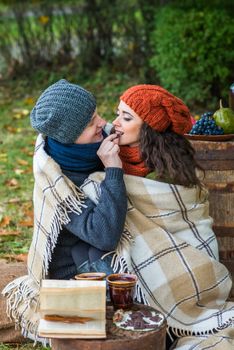 loving young couple sitting in the autumn garden