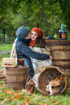 loving young couple sitting in the autumn garden