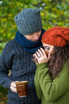 couple in love drinks coffee in the autumn garden