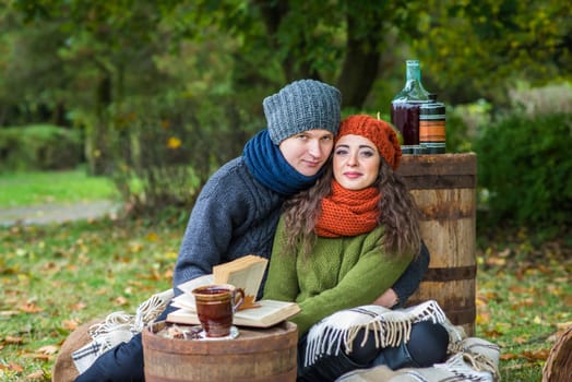 loving couple sitting in the autumn garden