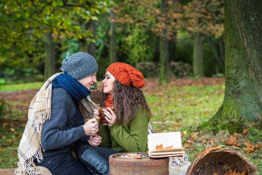 loving young couple sitting in the autumn garden