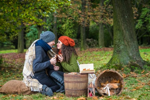 loving couple sitting in the autumn garden