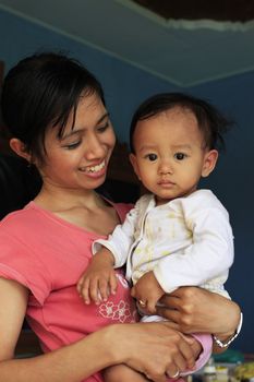 Young happy asian mother and her son