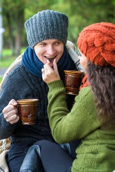 couple in love drinks coffee in the autumn garden