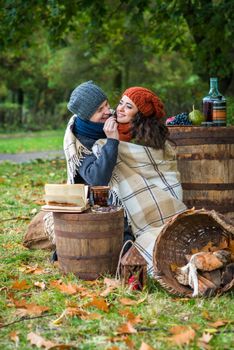 loving young couple sitting in the autumn garden