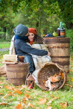 loving couple sitting in the autumn garden