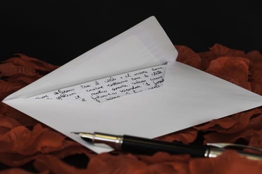 love letter on red rose petals and black background