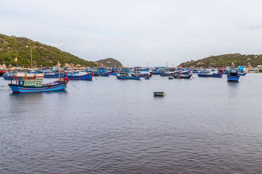Vietnamese fishing boats all harboured in a village bay