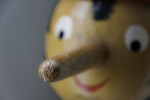 Close up of wooden puppet with long nose.