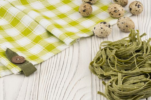 Raw green Italian pasta on old wooden table. Selective focus.