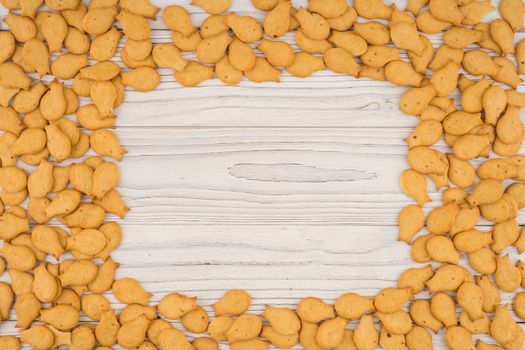 goldfish crackers on an old wooden table. Top view.
